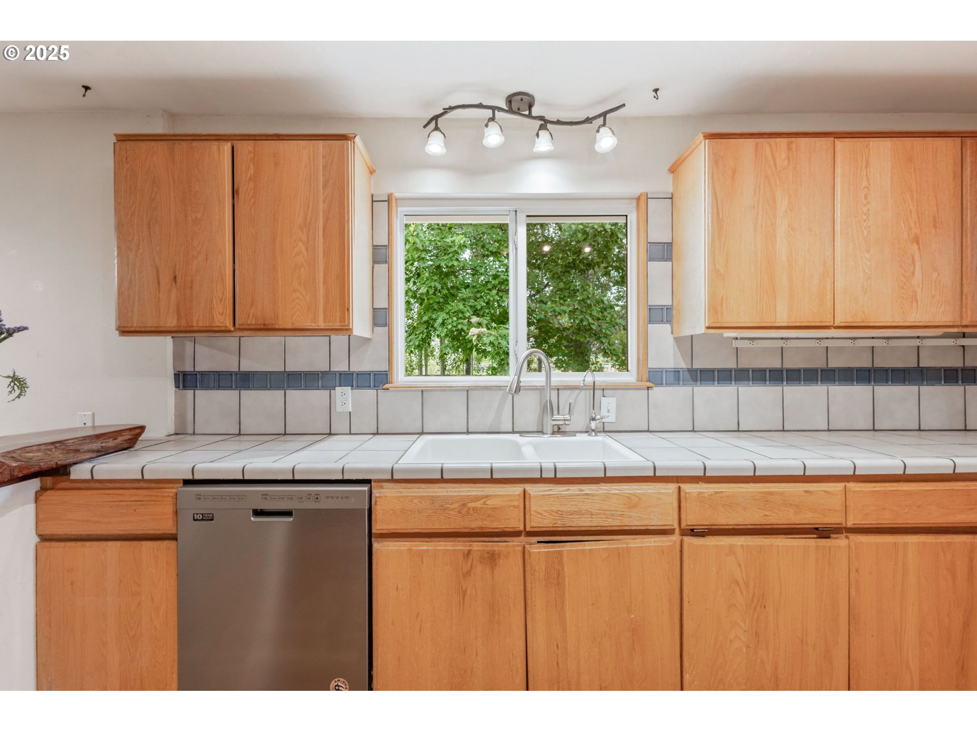 26315 Walker Road Bend, OR 97701 - Photo 6 of 45 a kitchen with a window wooden floor and a sink