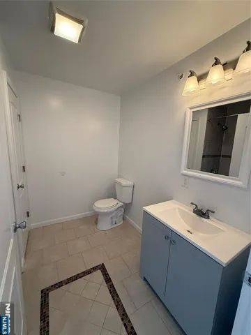 a bathroom with a sink toilet and mirror