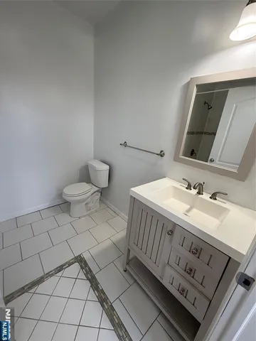 a bathroom with a sink a toilet and mirror