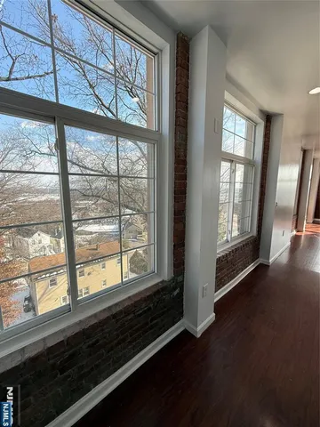 a view of a room with wooden floor and walls
