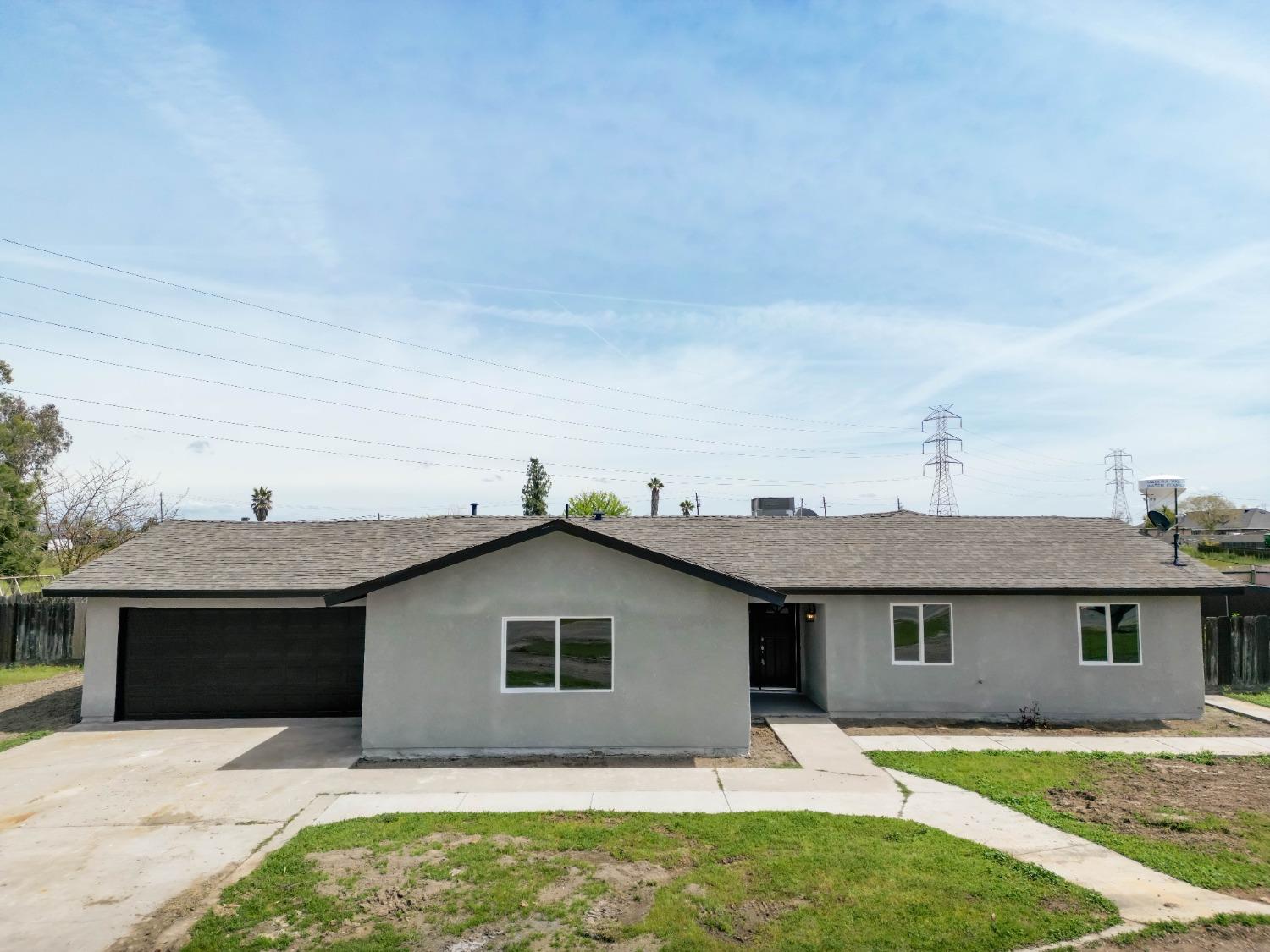 18071 Daley Road Madera, CA 93638 - Photo 1 of 25 a house that has a tree in front of it
