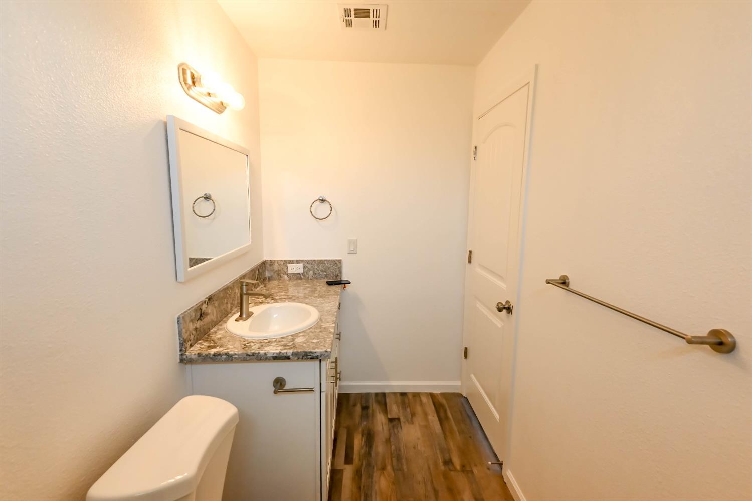 18071 Daley Road Madera, CA 93638 - Photo 15 of 25 a bathroom with a granite countertop sink and a mirror