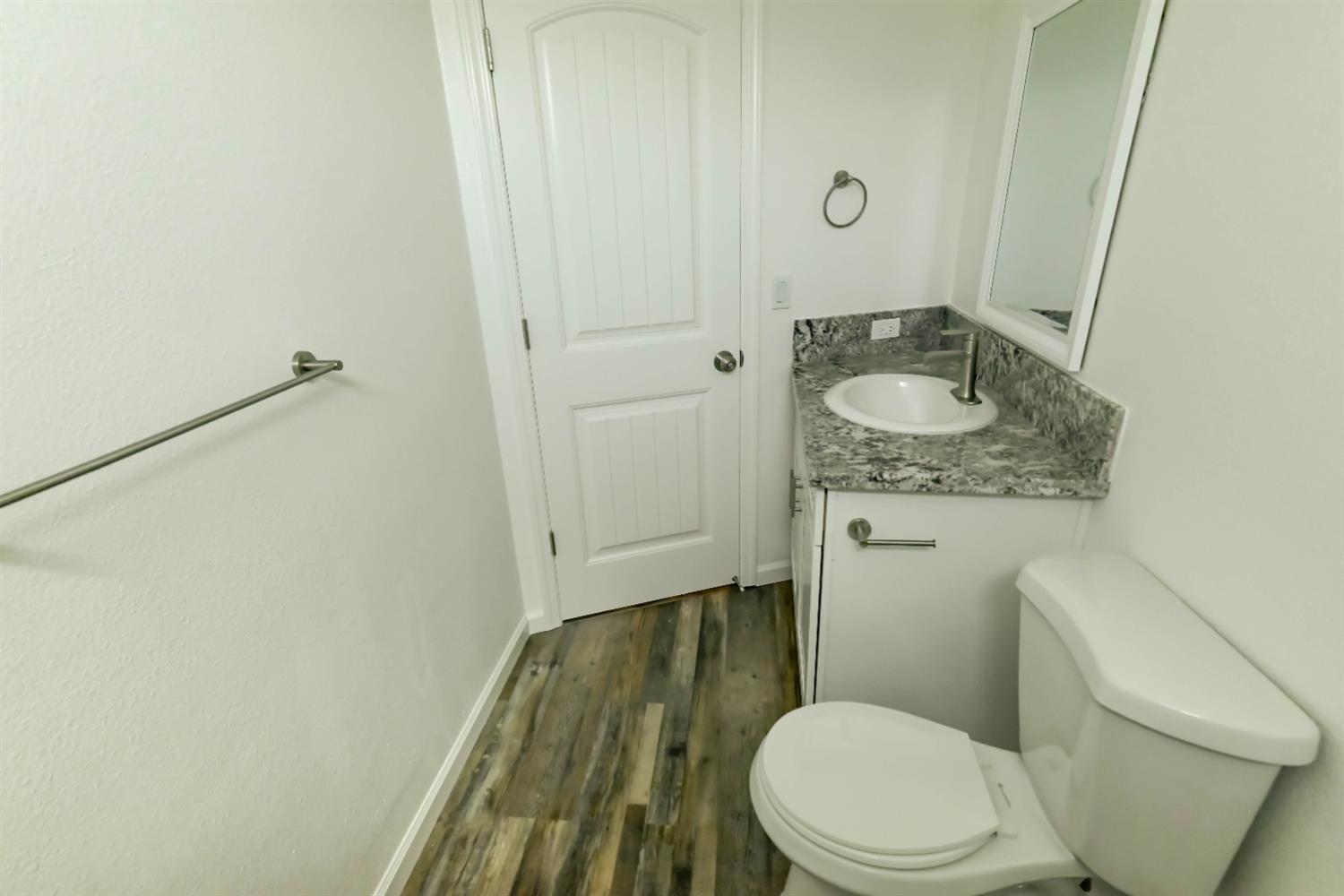 18071 Daley Road Madera, CA 93638 - Photo 18 of 25 a bathroom with a granite countertop toilet and a sink