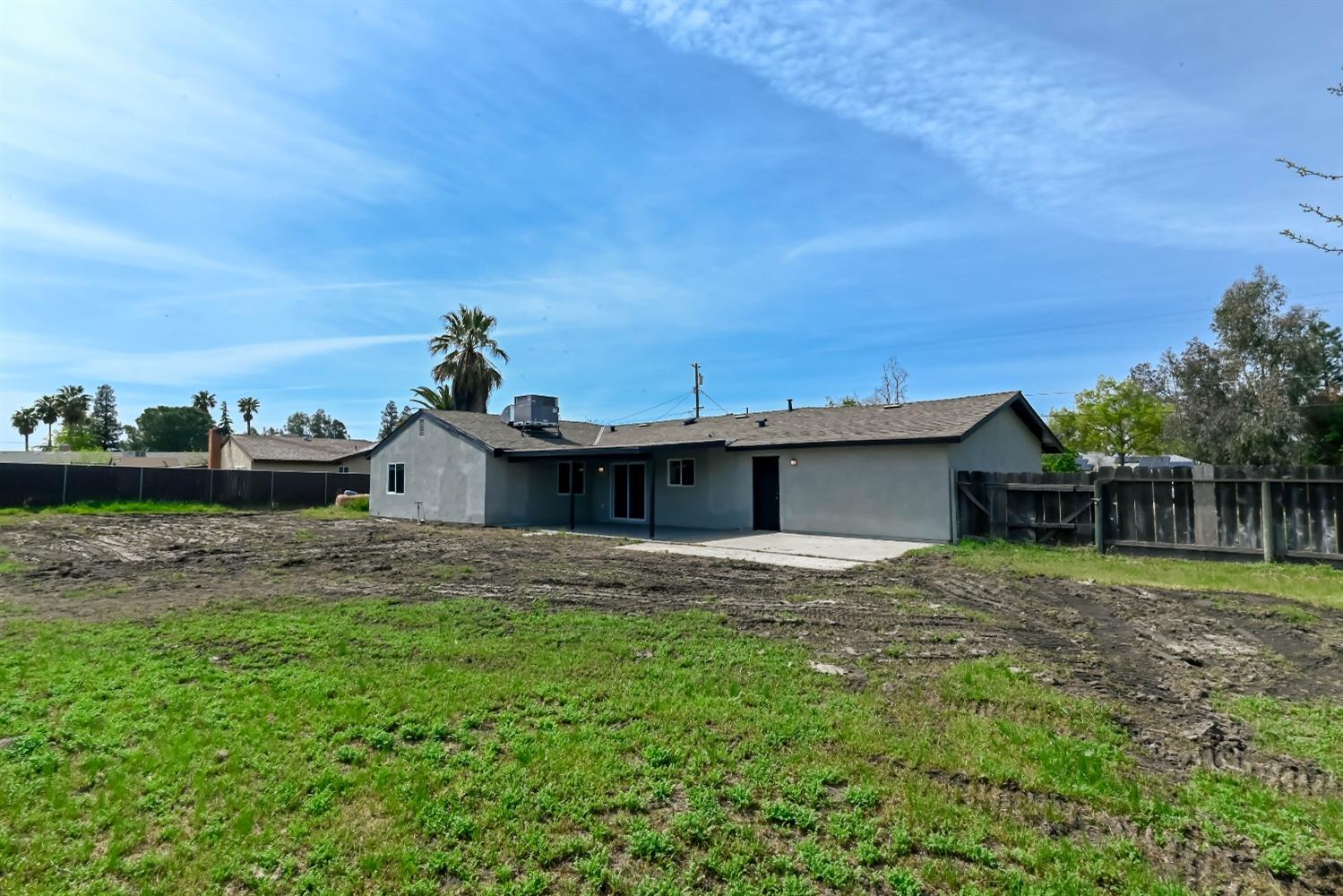 18071 Daley Road Madera, CA 93638 - Photo 24 of 25 a backyard of a house with plants and wooden fence