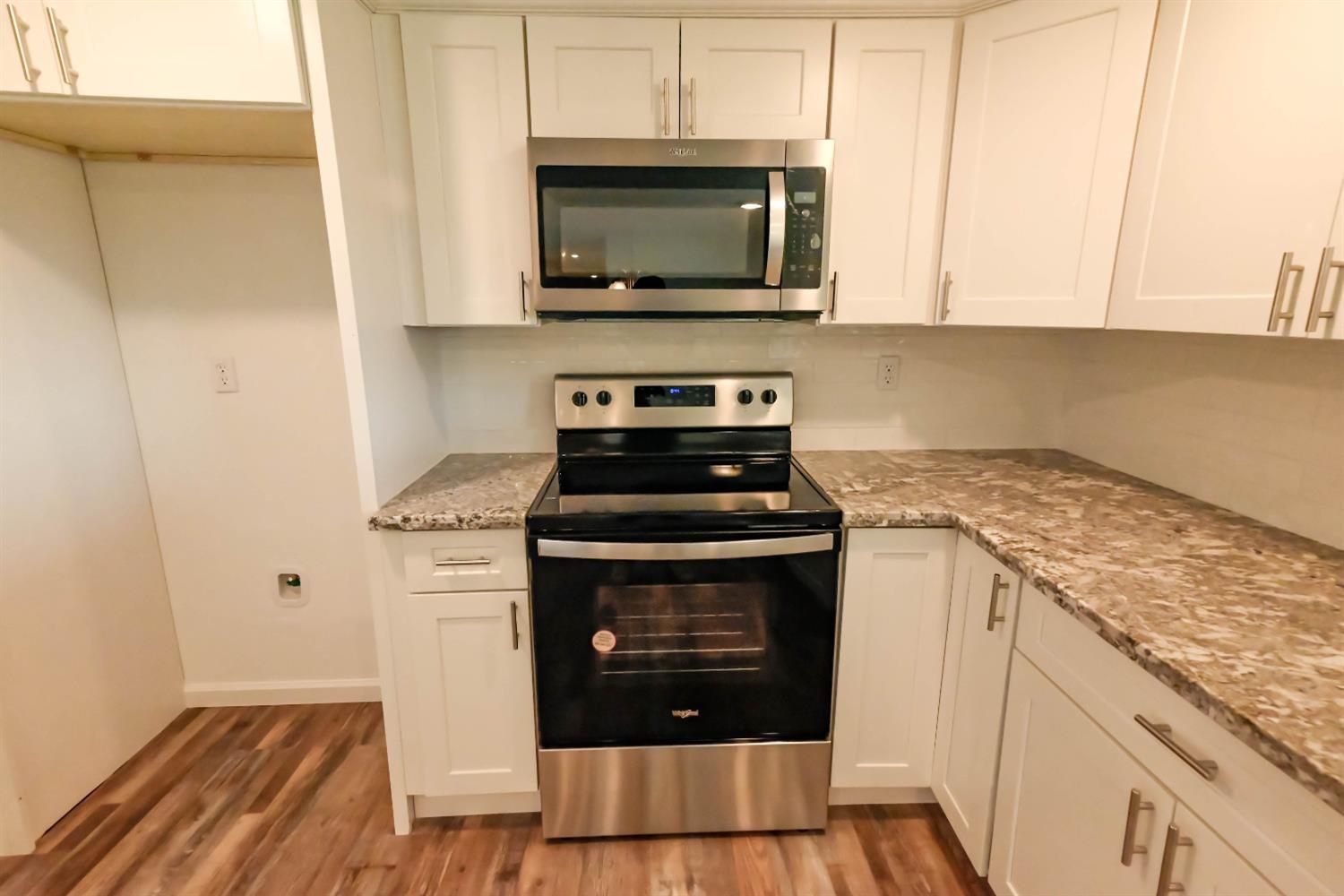 18071 Daley Road Madera, CA 93638 - Photo 25 of 25 a kitchen with stainless steel appliances granite countertop a stove microwave and sink
