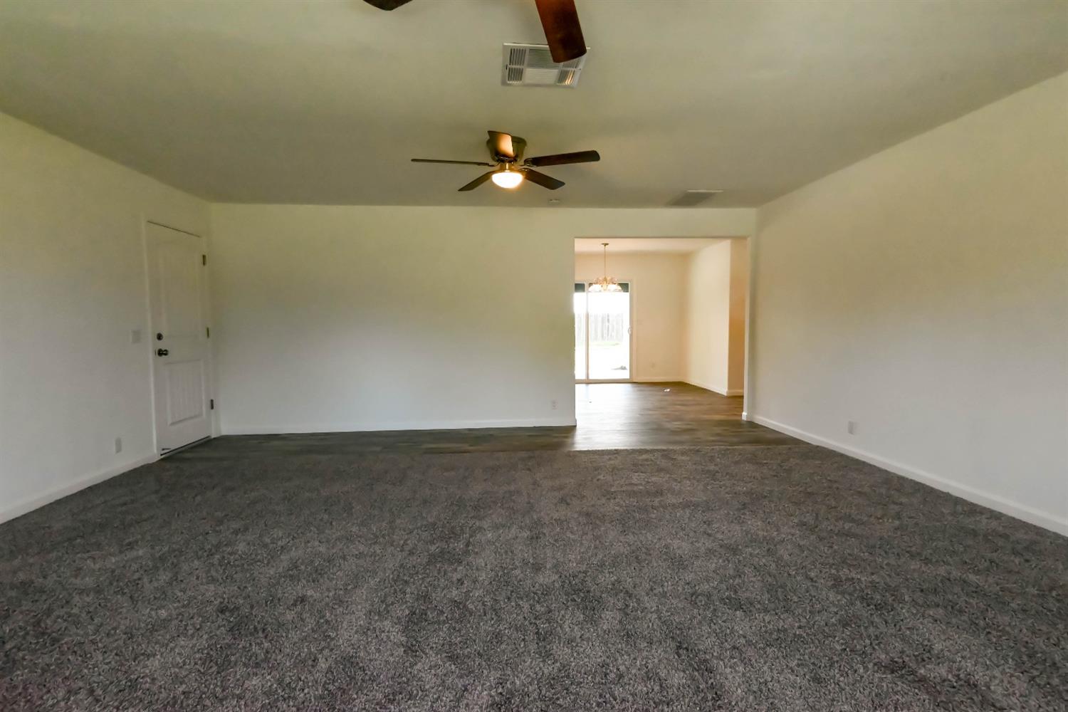18071 Daley Road Madera, CA 93638 - Photo 8 of 25 an empty room with fan and windows