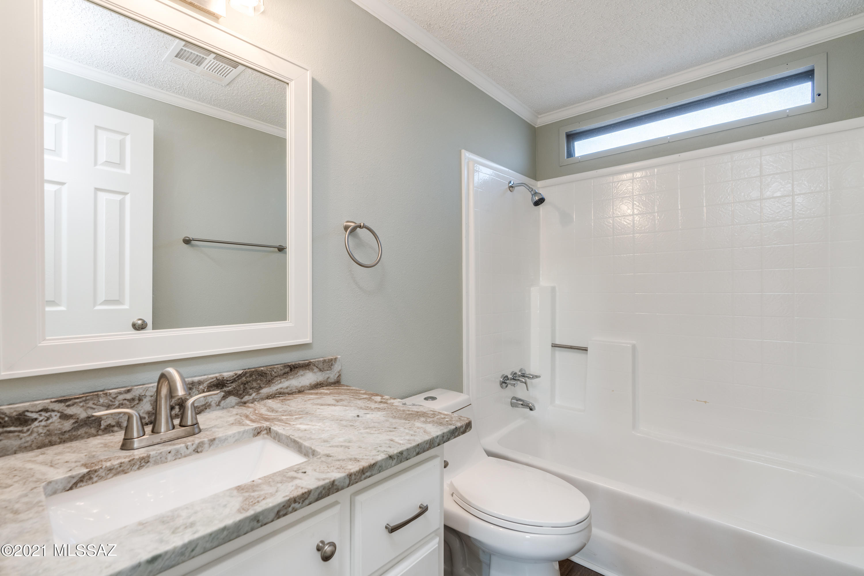 4489 East Wilds Road Tucson, AZ 85739 - Photo 32 of 50 a bathroom with a granite countertop sink a toilet and shower
