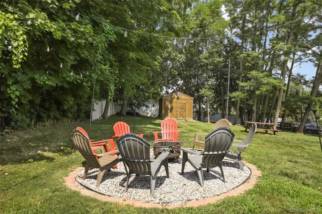 a view of a chairs and table in backyard