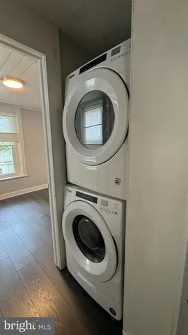 an empty room with wooden floor and closet