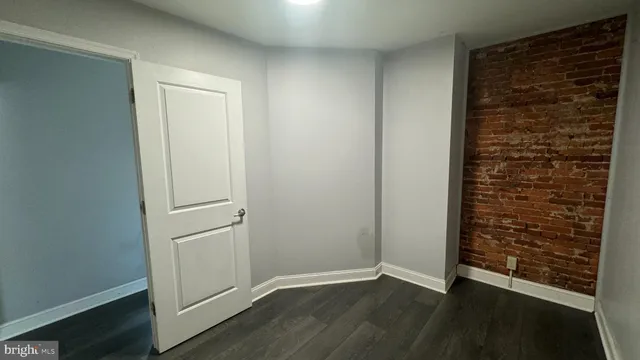 an empty room with wooden floor