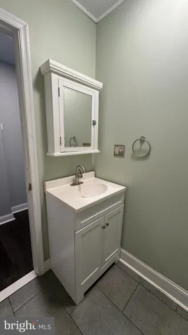 a white toilet sitting next to a white sink