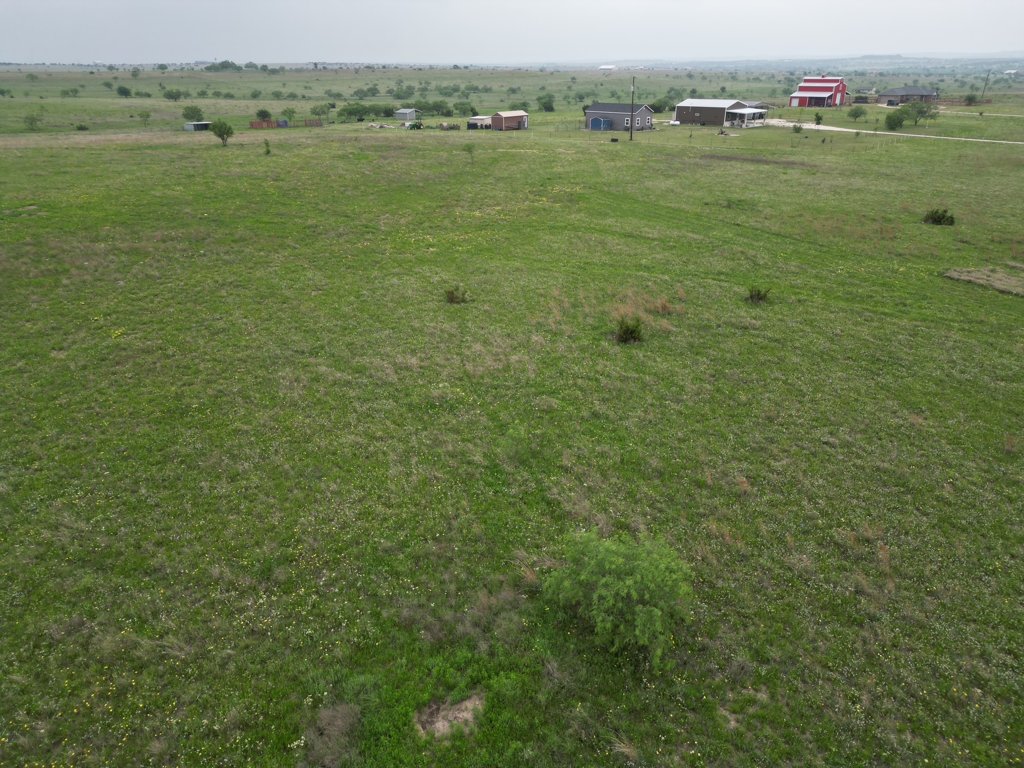 2332 County Road 2109 Lometa, TX 76853 - Photo 2 of 16 Expansive rural acreage with varied topography, scattered trees, and distant structures