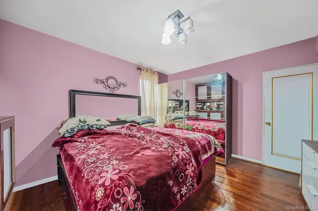 a bedroom with a large bed and a chandelier