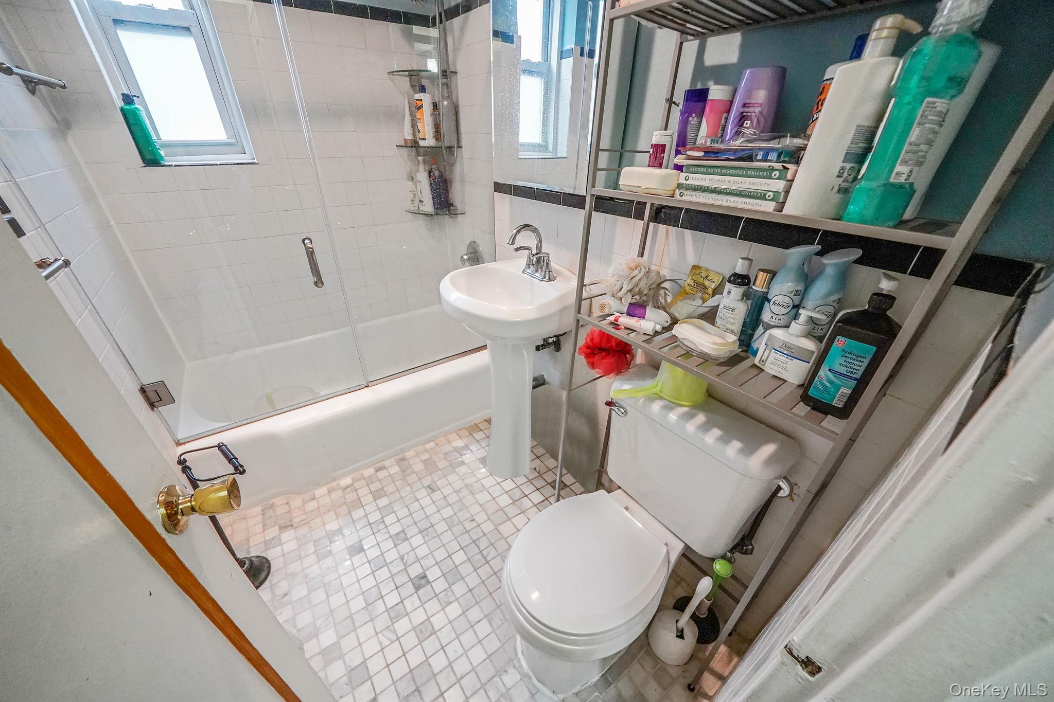 39-45 51st Street, Unit 5C Queens, NY 11377 - Photo 14 of 17 a bathroom with a toilet sink and mirror