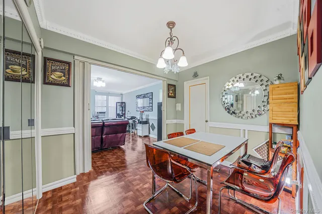 a view of a dining room with furniture and a chandelier