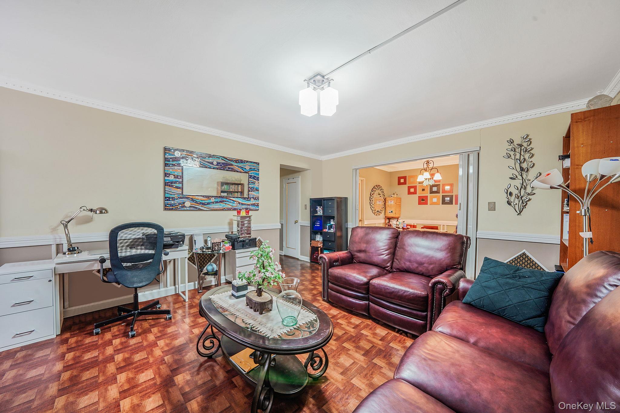 39-45 51st Street, Unit 5C Queens, NY 11377 - Photo 8 of 17 a living room with furniture a rug and a window