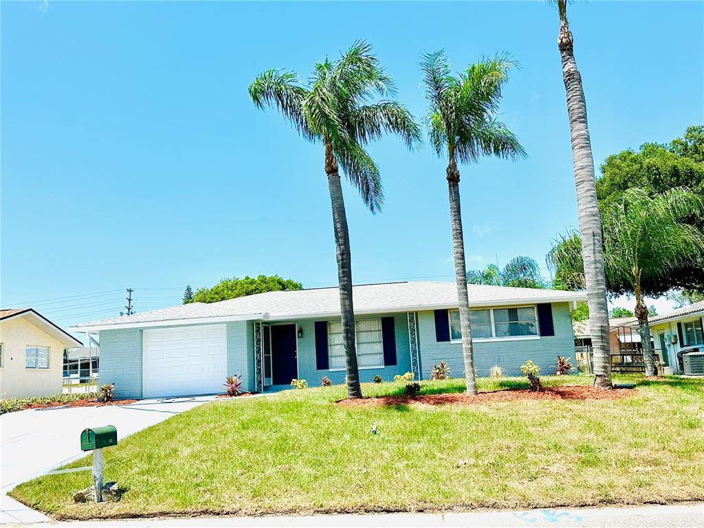 a front view of a house with a yard patio and fire pit