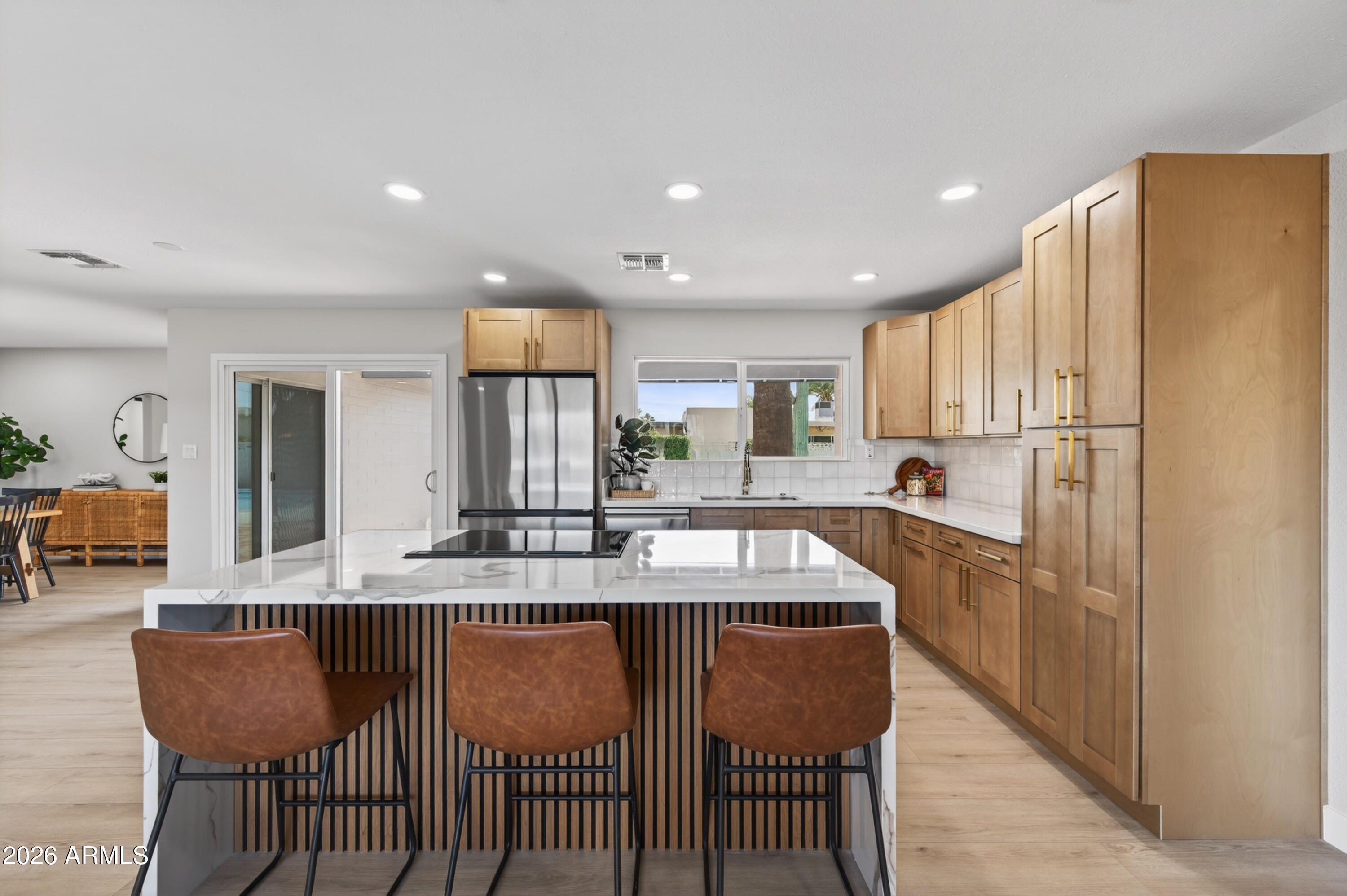 3422 South Terrace Road Tempe, AZ 85282 - Photo 4 of 43 a kitchen with stainless steel appliances granite countertop a dining table chairs refrigerator and sink