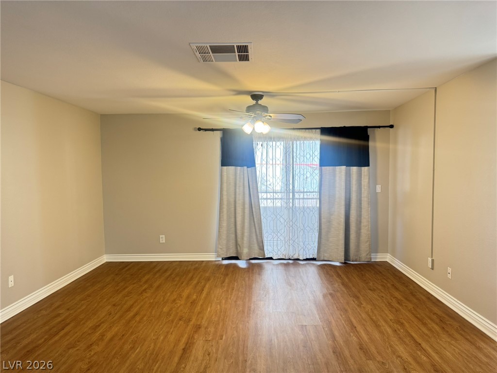 5141 South Lindell Road, Unit 102 Las Vegas, NV 89118 - Photo 4 of 17 A living space offers resilient flooring and a ceiling fan for comfort.