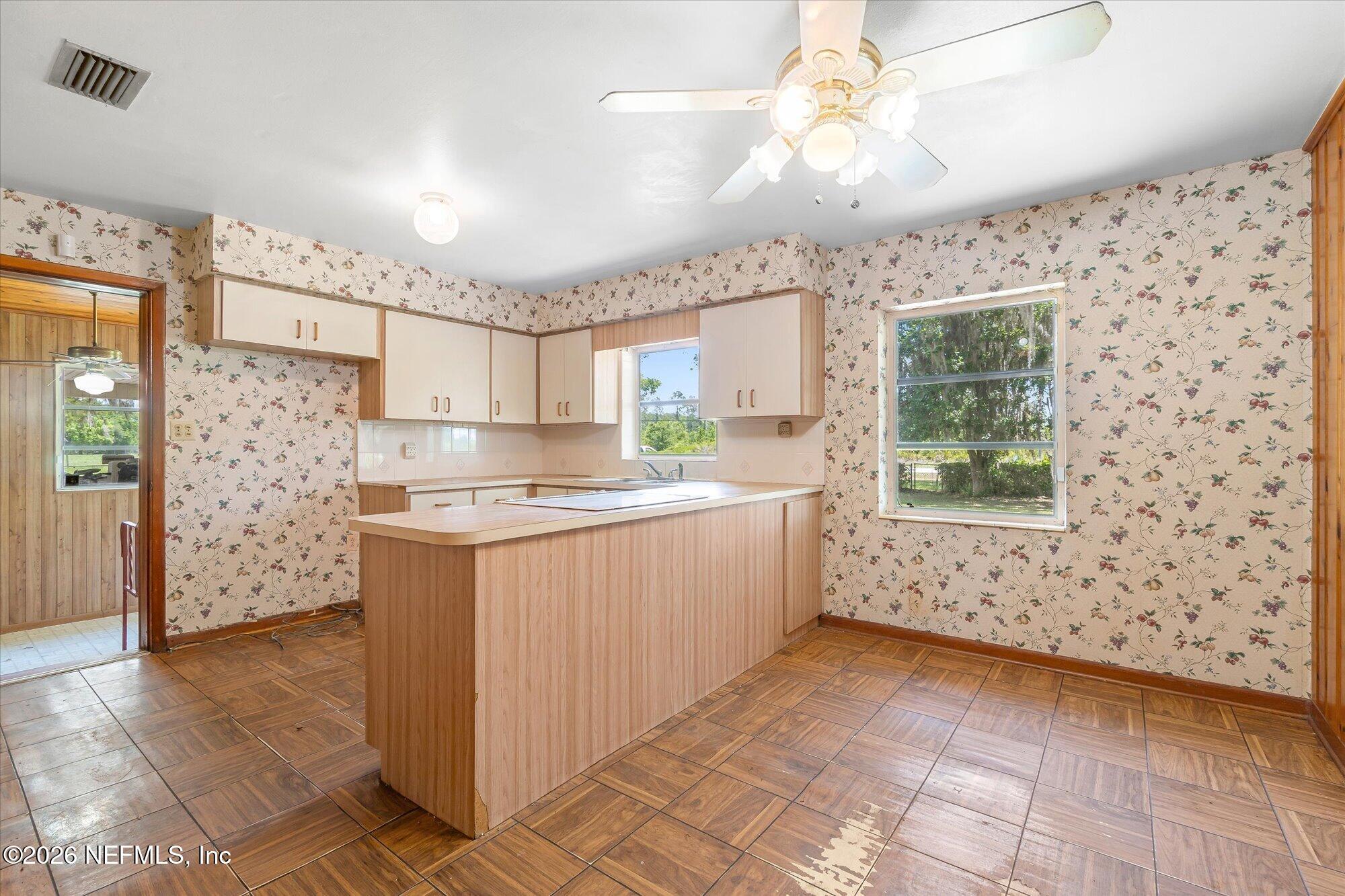 786 West River Road Palatka, FL 32177 - Photo 14 of 53 a kitchen with granite countertop a stove a sink and a refrigerator