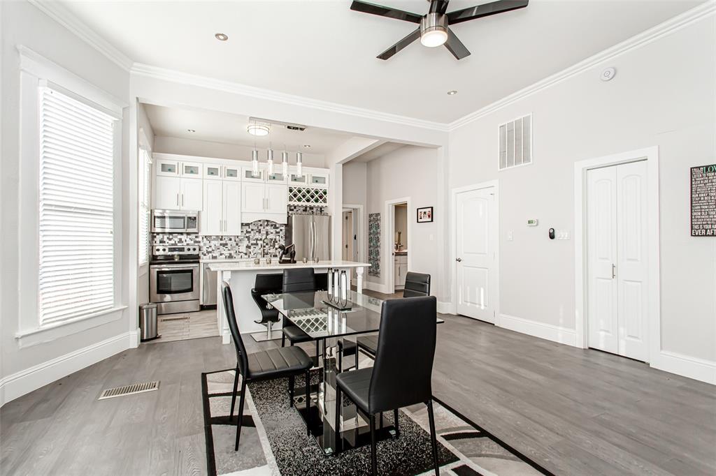 4719 Junius Street, Unit 1 Dallas, TX 75246 - Photo 11 of 40 a view of a dining room with furniture window and wooden floor