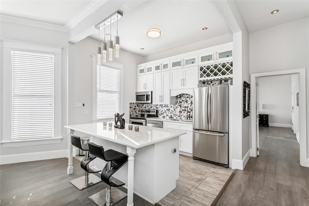 4719 Junius Street, Unit 1 Dallas, TX 75246 - Photo 16 of 40 a kitchen with refrigerator and chairs
