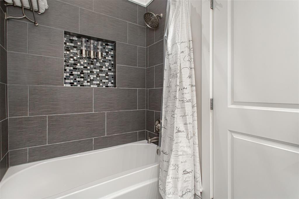4719 Junius Street, Unit 1 Dallas, TX 75246 - Photo 23 of 40 a bathroom with a shower and a bathtub