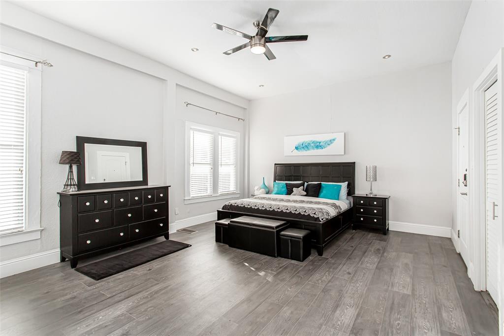 4719 Junius Street, Unit 1 Dallas, TX 75246 - Photo 24 of 40 a bedroom with a bed and a dresser