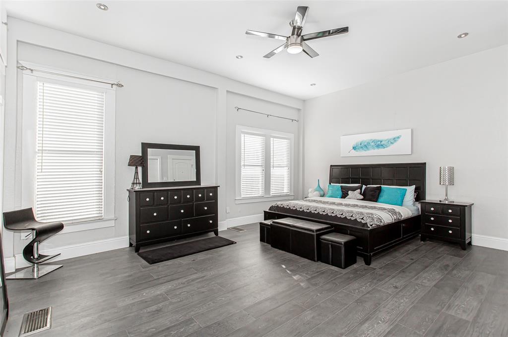 4719 Junius Street, Unit 1 Dallas, TX 75246 - Photo 25 of 40 a bedroom with a bed and a dresser