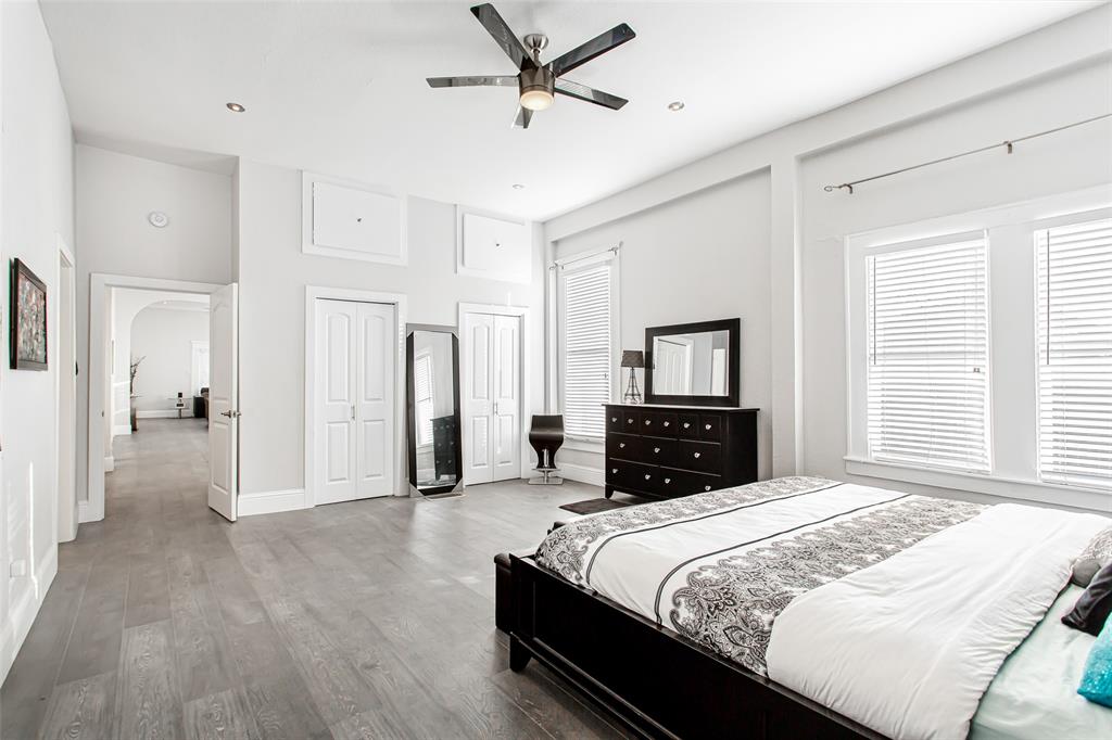 4719 Junius Street, Unit 1 Dallas, TX 75246 - Photo 26 of 40 a bedroom with a bed and a tv