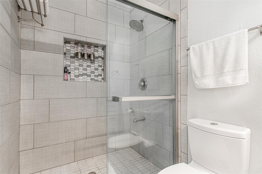 4719 Junius Street, Unit 1 Dallas, TX 75246 - Photo 30 of 40 a bathroom with a toilet and shower