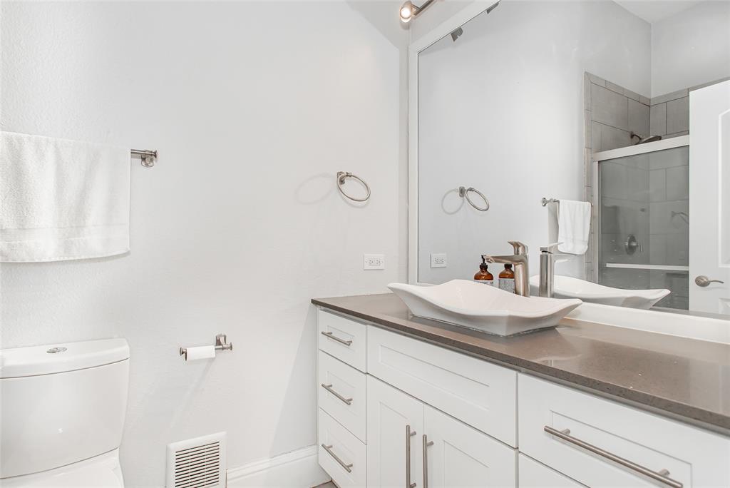 4719 Junius Street, Unit 1 Dallas, TX 75246 - Photo 31 of 40 a bathroom with a sink and a toilet