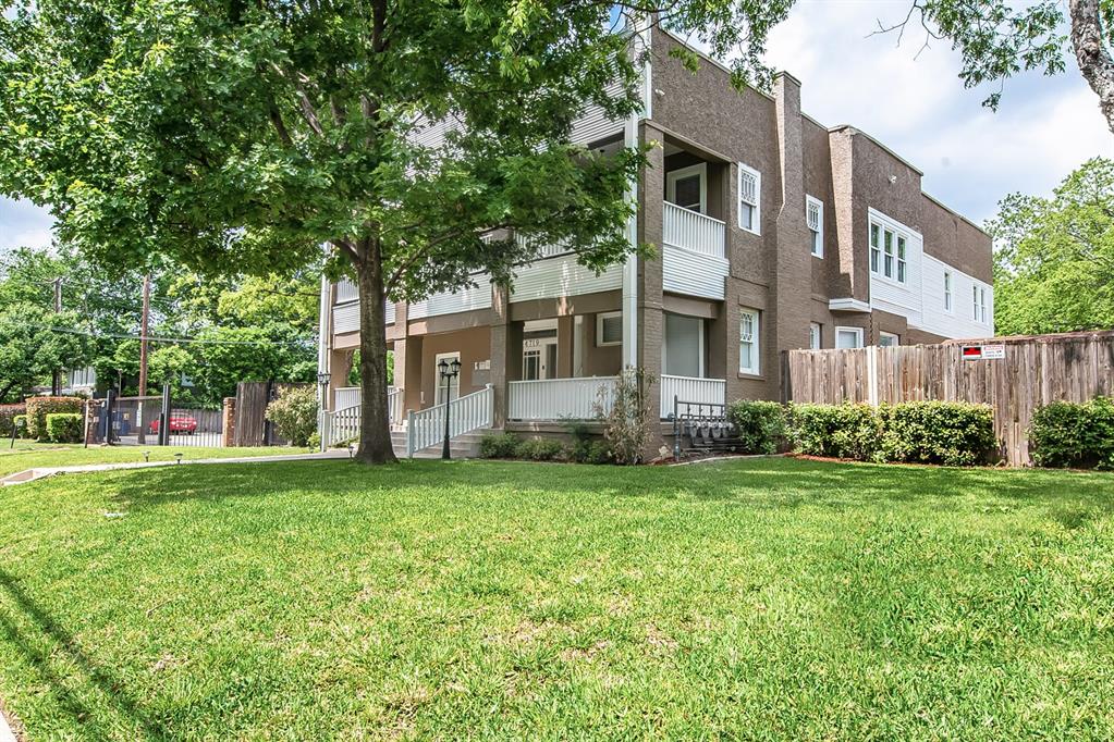 4719 Junius Street, Unit 1 Dallas, TX 75246 - Photo 32 of 40 a front view of a house with a yard and trees