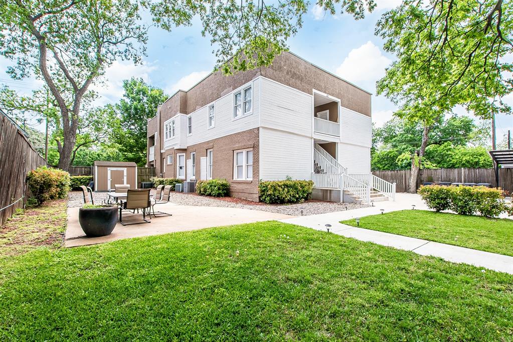 4719 Junius Street, Unit 1 Dallas, TX 75246 - Photo 37 of 40 a front view of a house with patio and garden