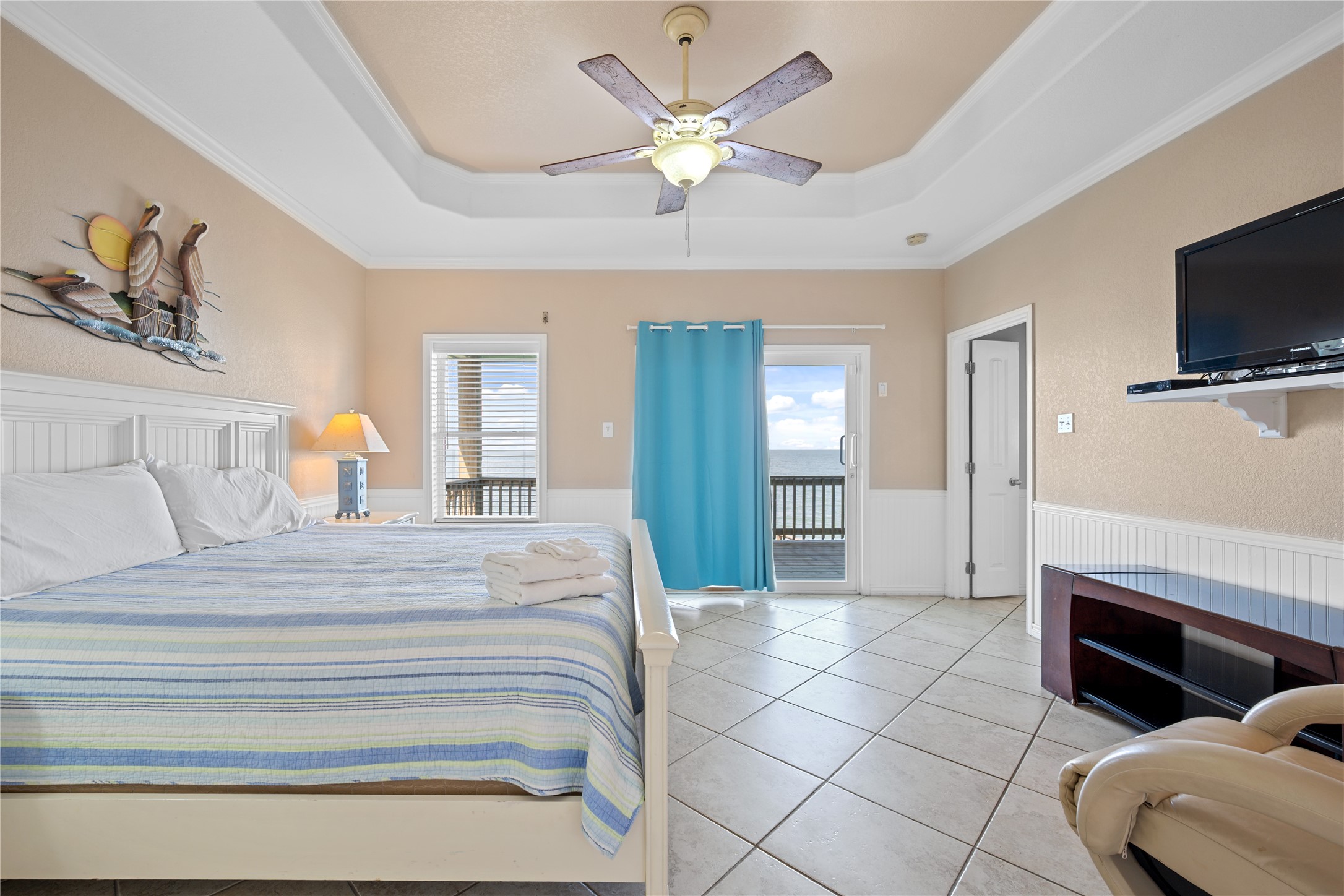740 Copano Cove Road Rockport, TX 78382 - Photo 21 of 35 a bedroom with a bed and a television
