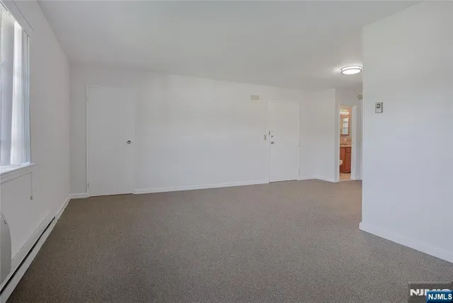 an empty room with a empty space and window