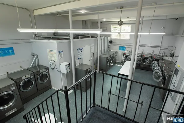 a view of a storage and utility room with washer and dryer
