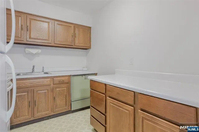 a kitchen with stainless steel appliances granite countertop a sink and cabinets