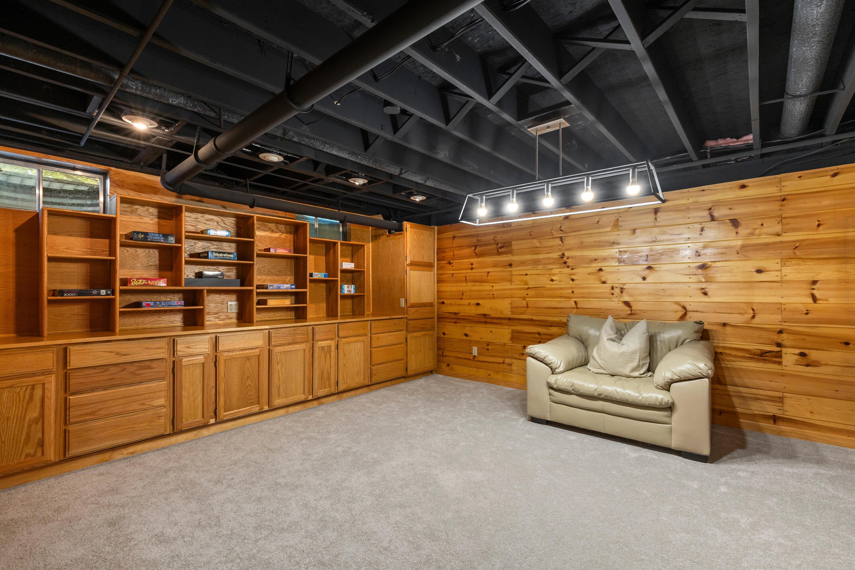 1515 Dale Ford Road Delaware, OH 43015 - Photo 49 of 74 • New light sand carpet ~ 2025 • Wood planked walls • Built-in shelves • Billiards light remains