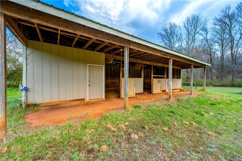 Lot 18 Bear Creek Road Statham, GA 30666 - Photo 13 of 21 a backyard of a house with yard and outdoor seating