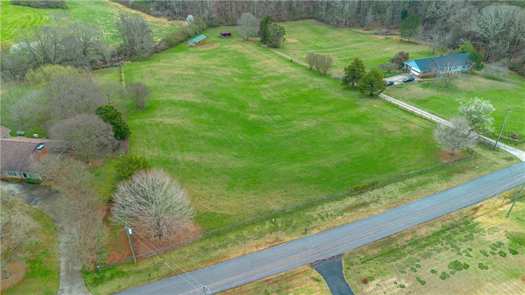 Lot 18 Bear Creek Road Statham, GA 30666 - Photo 3 of 21 a backyard of a house with a yard and outdoor seating