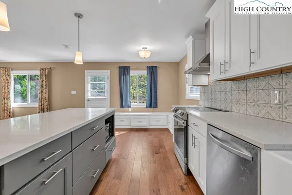 a kitchen with kitchen island granite countertop a sink stove and refrigerator