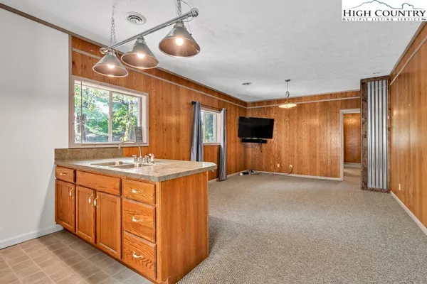 a kitchen with a stove cabinets and window