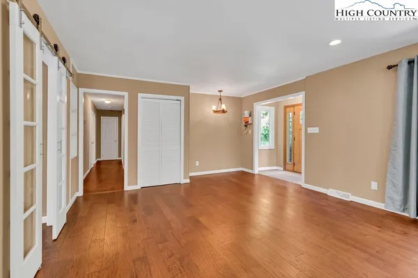 a view of an empty room with wooden floor