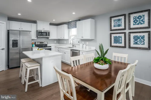 a kitchen with a table and chairs