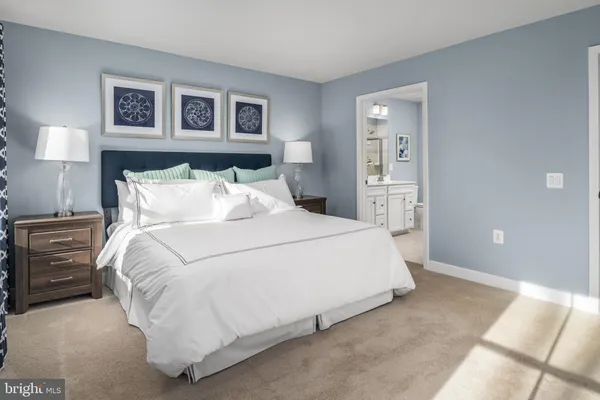 a bedroom with a bed and a night stand