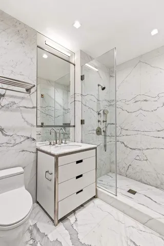 a bedroom with two beds and a large window