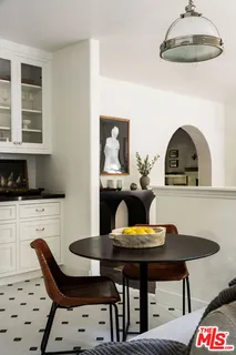 a kitchen with stainless steel appliances granite countertop white cabinets and a sink