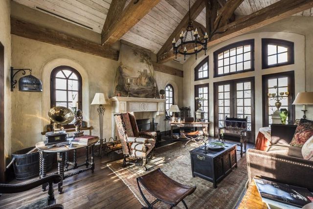 a view of staircase with a metal railing and a chandelier