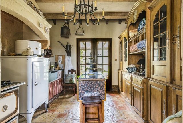 a living room with furniture a fireplace and large windows
